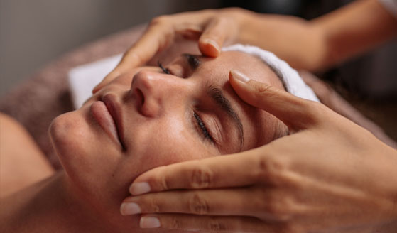 Woman getting her face massaged.