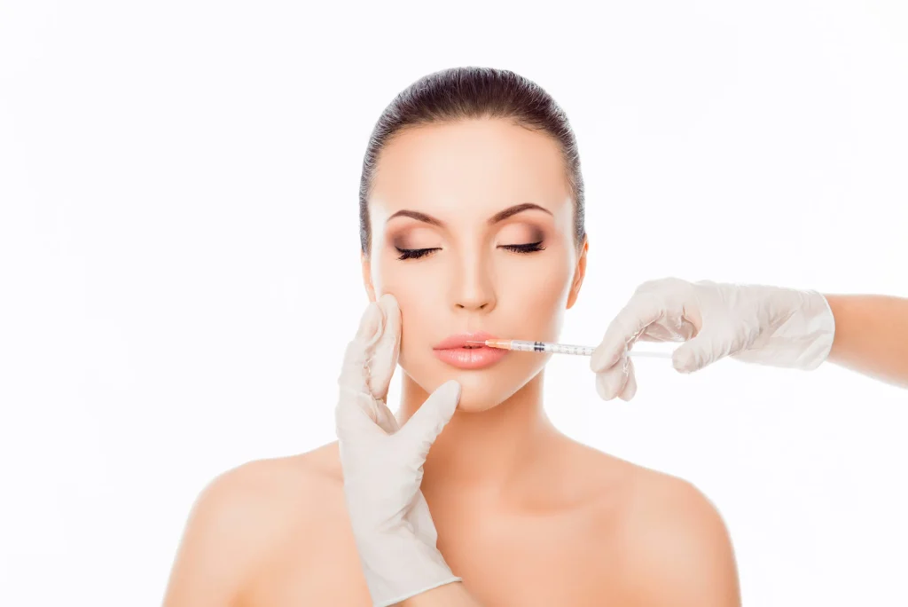 Esthetician injecting Botox into woman’s lips
