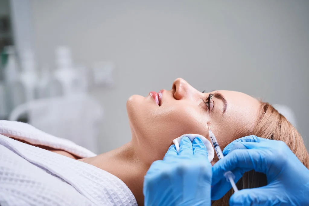 Young woman getting dermal fillers into crow's feet