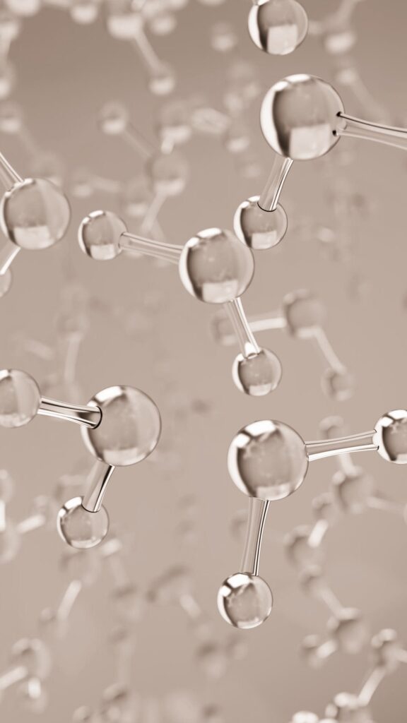 A close-up of interconnected transparent spheres representing a molecular structure on a blue background.