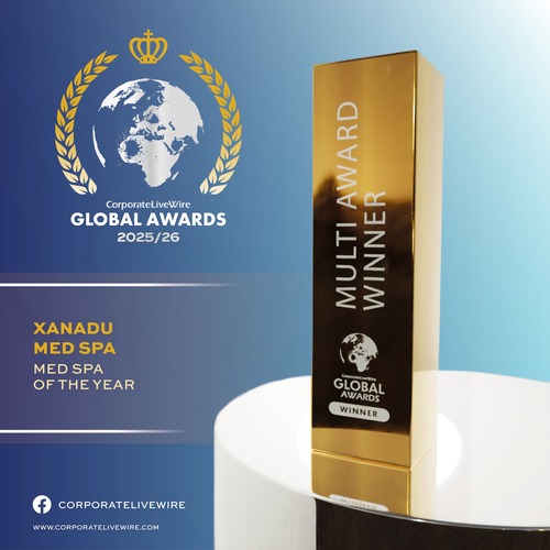 Gold trophy labeled "Multi Award Winner Global Awards" on a white table, with a blue background displaying "CorporateLiveWire Global Awards 2025/26" and "Xanadu Med Spa, Med Spa of the Year" text.